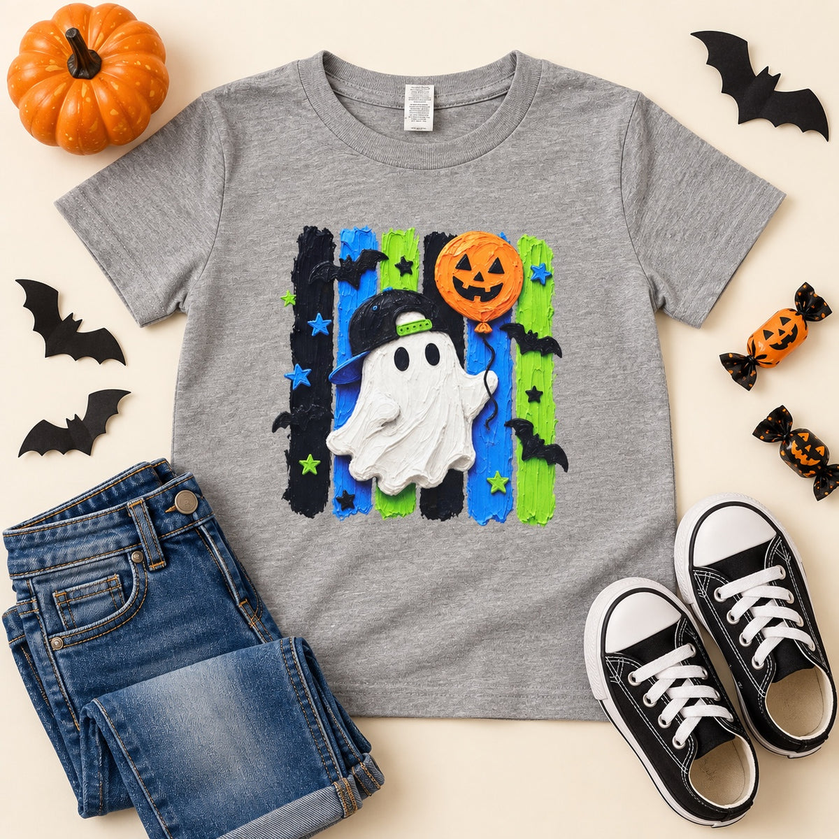 Gray youth Halloween tee with a ghost in a backwards cap, pumpkin balloon, and blue and green stripes
