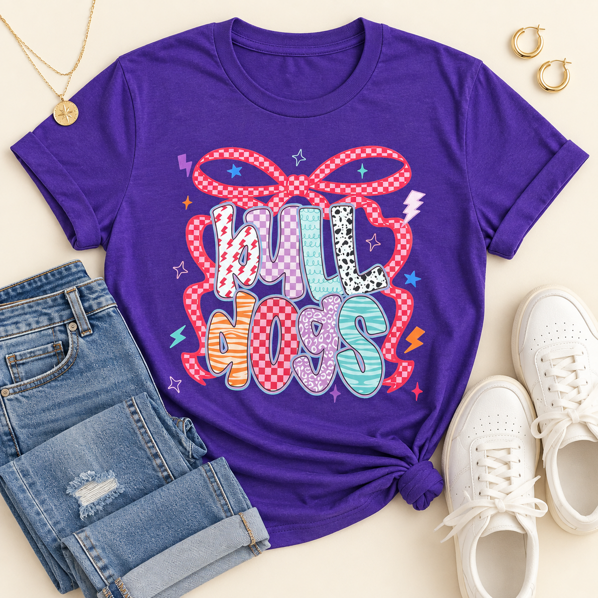 Purple short sleeve Bulldogs graphic T-shirt with colorful lettering and red checkered bow
