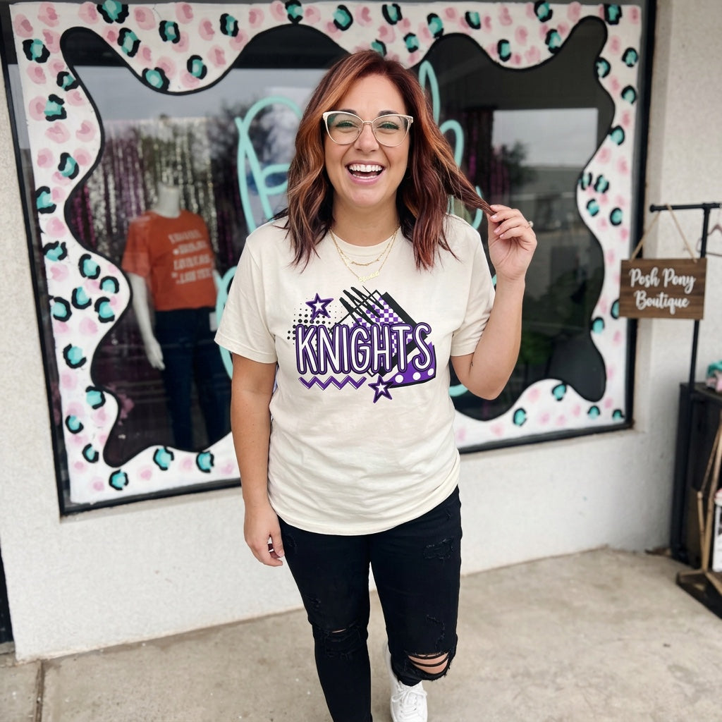Cream KNIGHTS graphic tee with purple and black lettering and stars