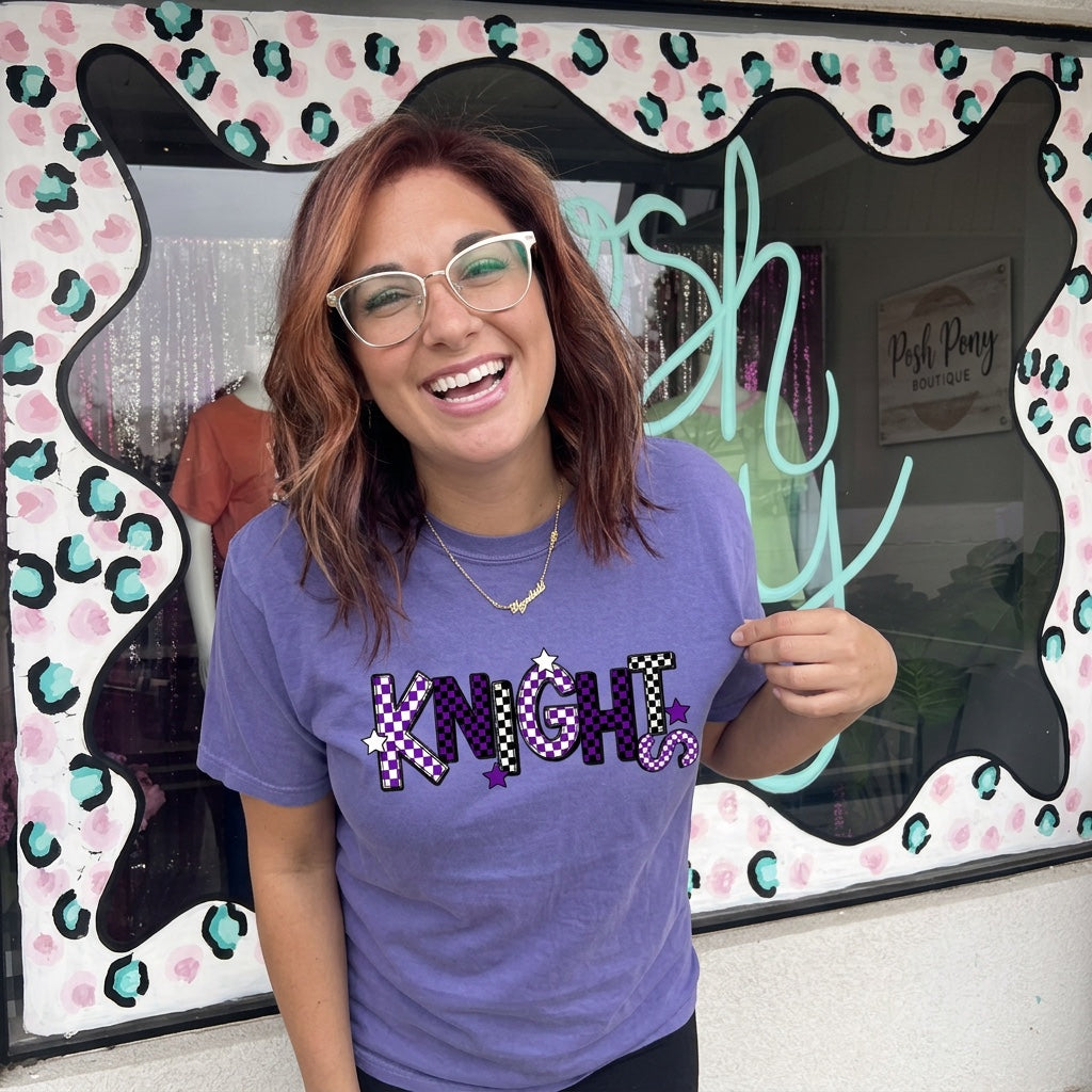Purple KNIGHTS graphic tee with checkered lettering and stars
