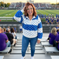 Blue and white polka dot pullover at football stadium