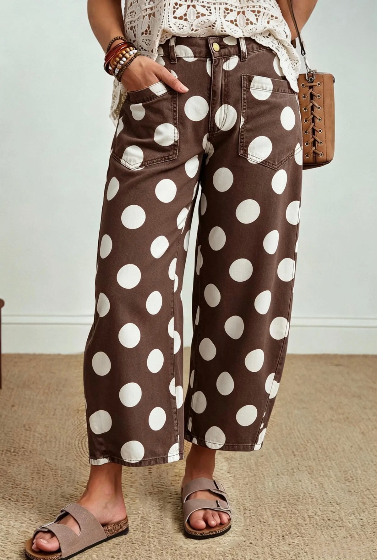 Front view of brown jeans with oversized white polka dots and front patch pockets