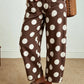 Second front view of brown and white polka dot wide leg jeans